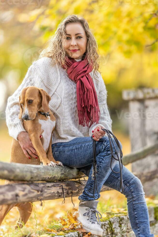 Portrait of a young woman in an autumn outfit with her pet photo
