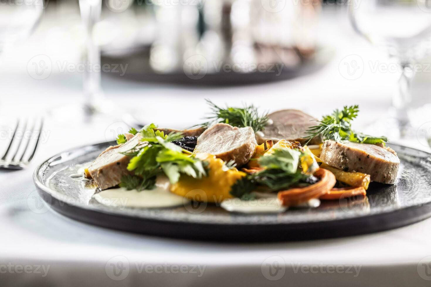 Baked pork and carrots with carrot puree and coriander leaves photo