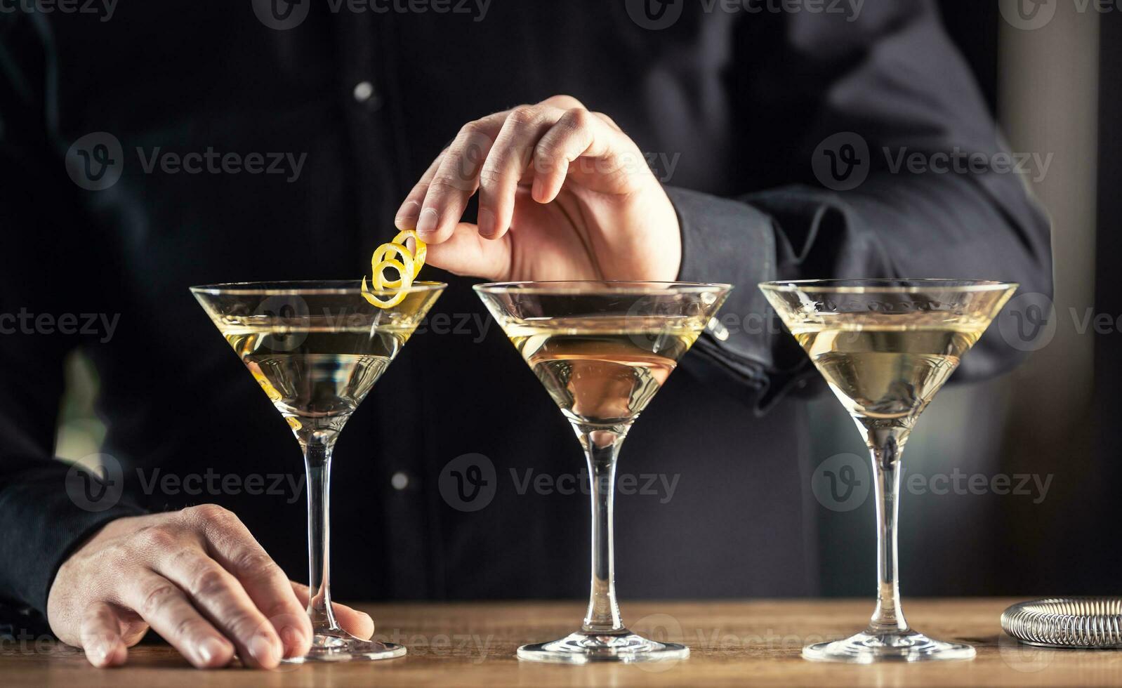 Dry Martini short drink cocktail with gin, dry vermouth and a lemon zest garnish photo