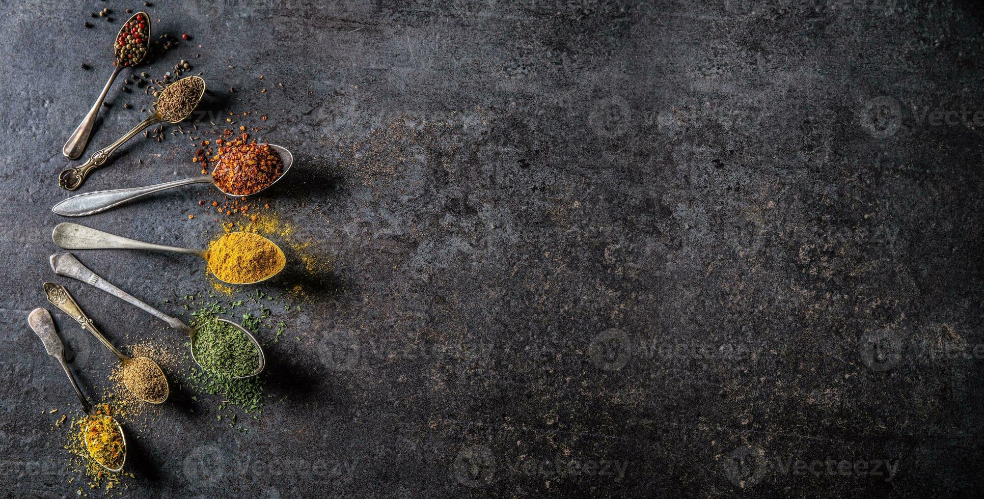 Spices and herbs for cooking on dark background - Top of view photo