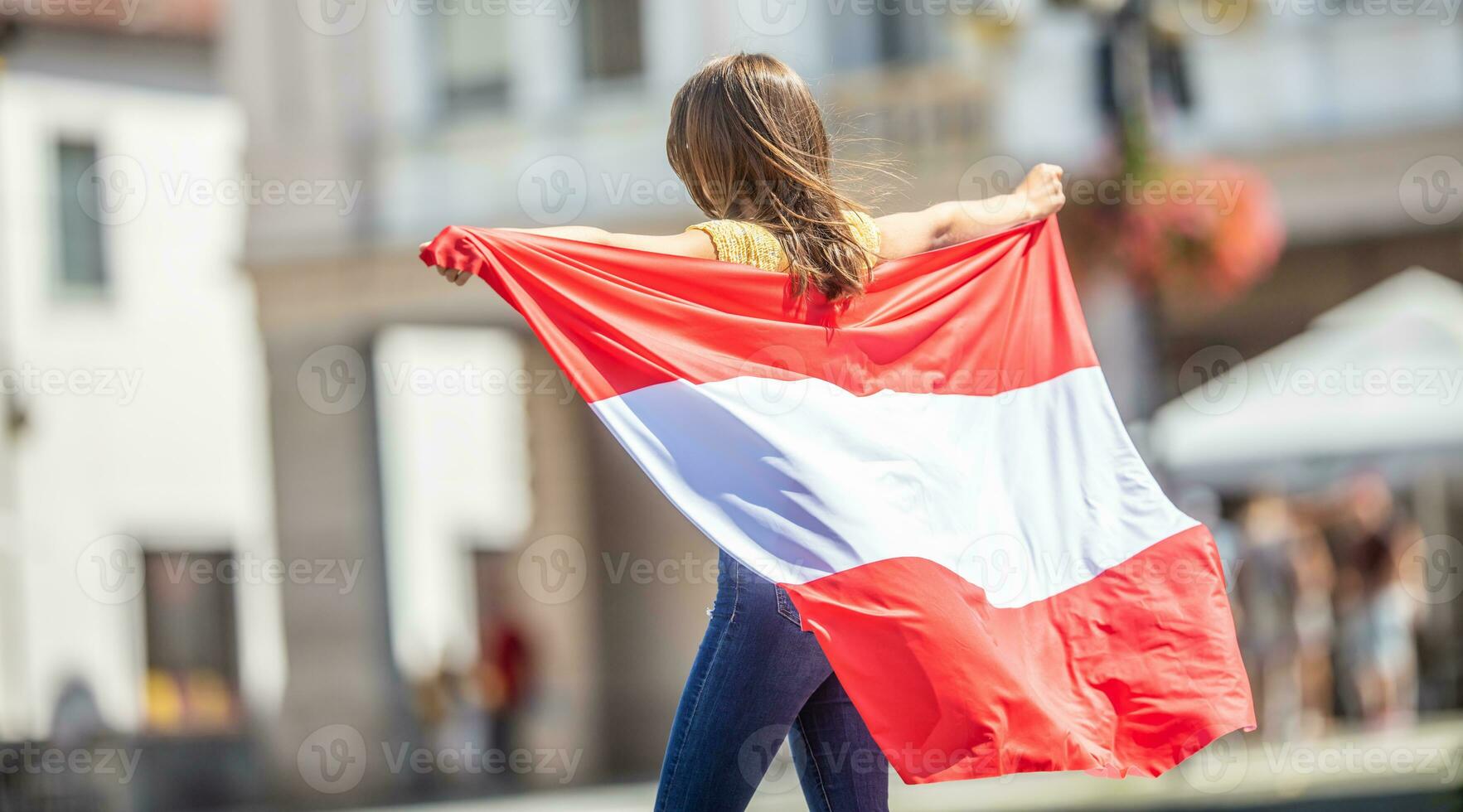 Attractive happy young girl with the Austria flag photo