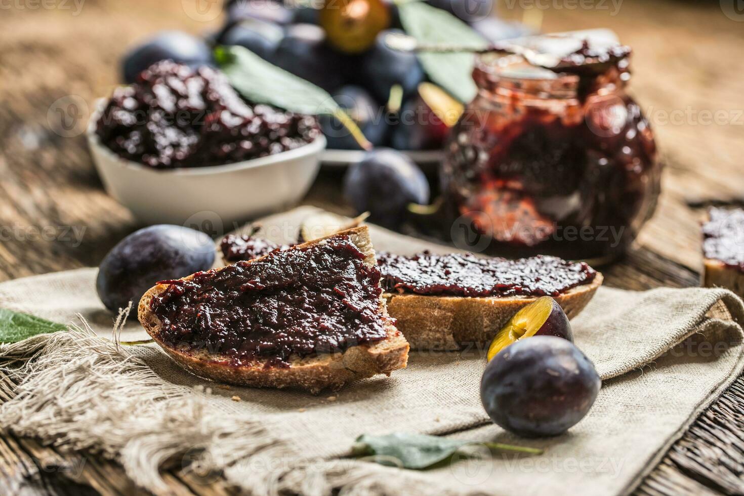 Breakfast from homemade plum jam bread and ripe plums. photo