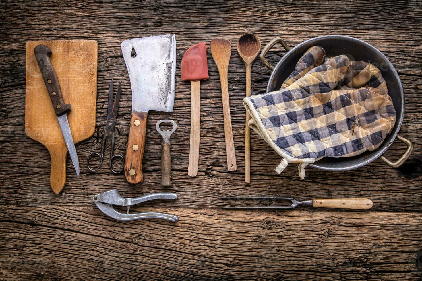 Top of view on Vintage kitchen utensils on rustic wood background. photo