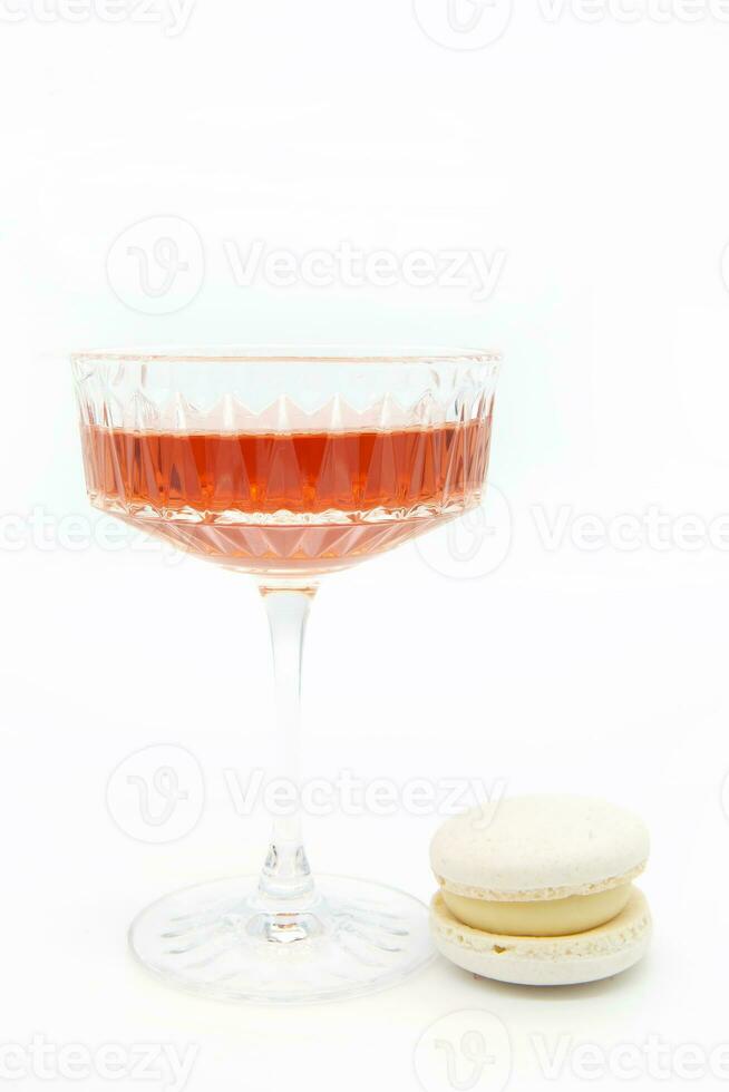 Macaroon and wine on a light background. photo