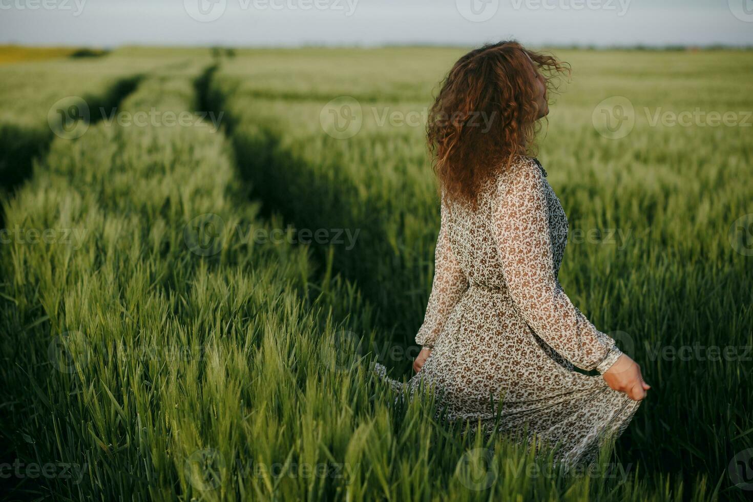 Cute girl standing on the field photo