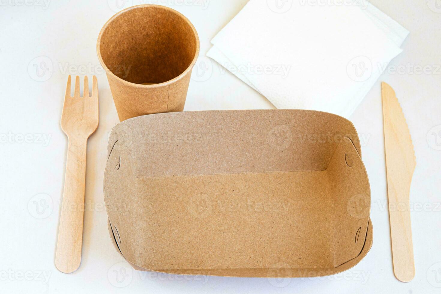 Disposable environmentally eco friendly food packaging. Brown craft paper containers, drink glasses, forks and knifes. Mockup, template photo
