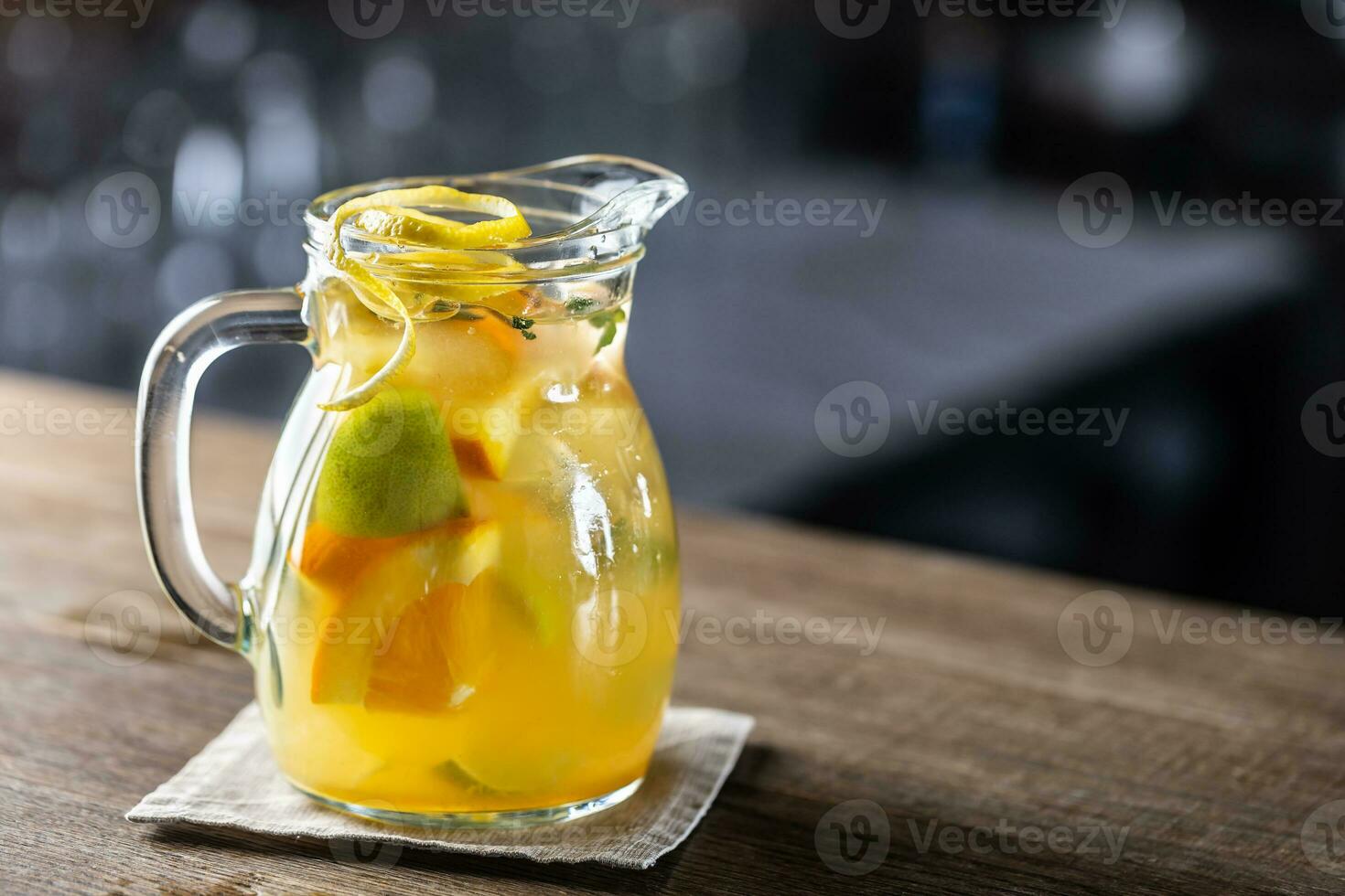 Fresh lemonade with various citruses in a full jar with fresh wedges of fruit inside photo