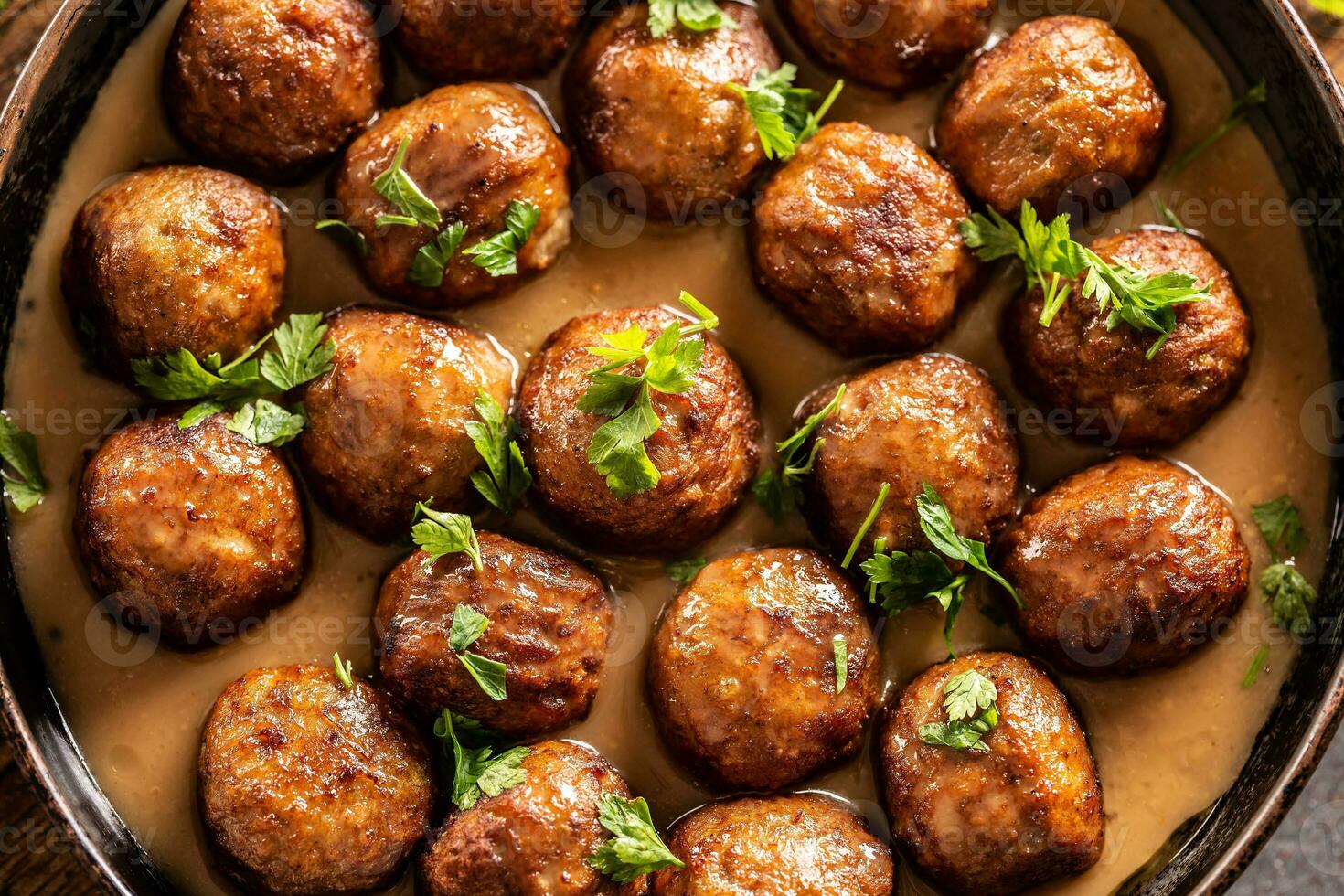 Top view of a pan with freshly-made kottbullar meatballs in a sauce photo