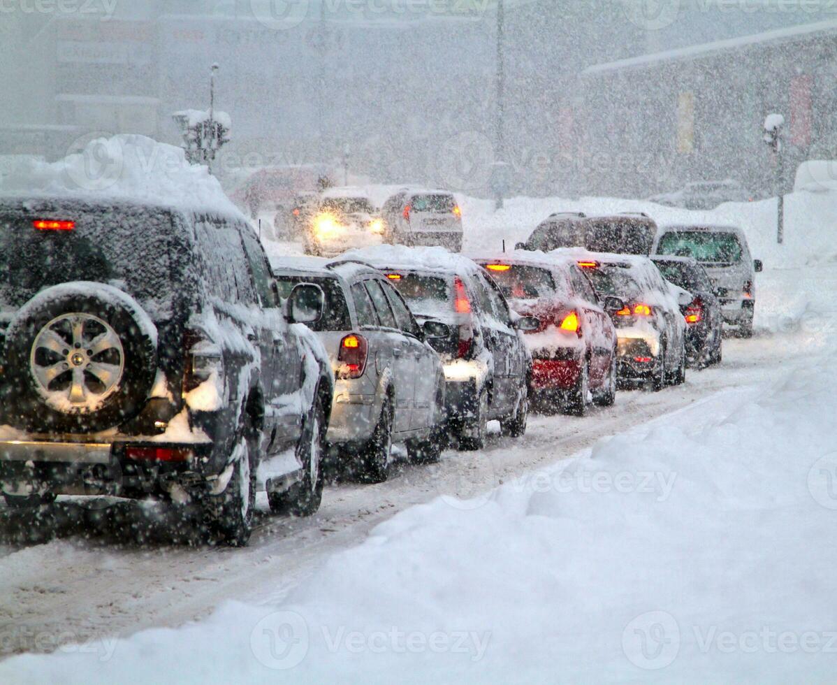 Snow calamity on the road, heavy snowfall limited road traffic. Blizzard and snowfall winter weather on hihway photo