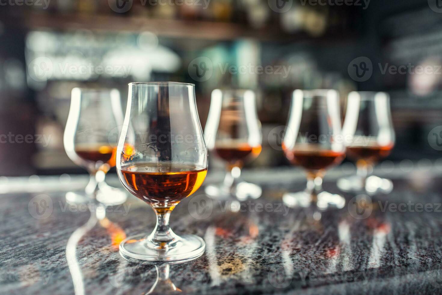 Cups with a cognac rum brandy or whiskey drink. photo