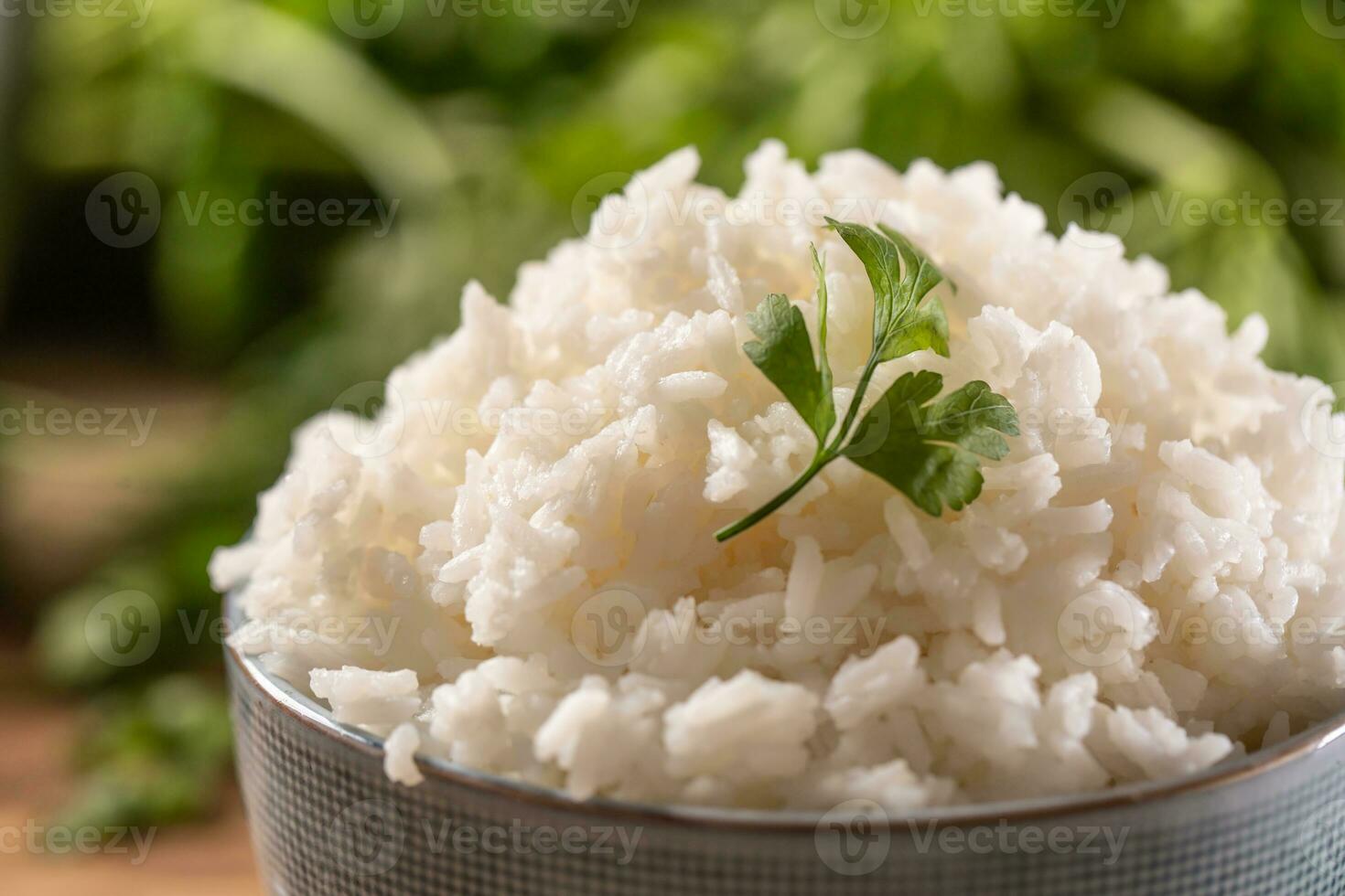 Cooked rice in a bowl with fresh parsley photo