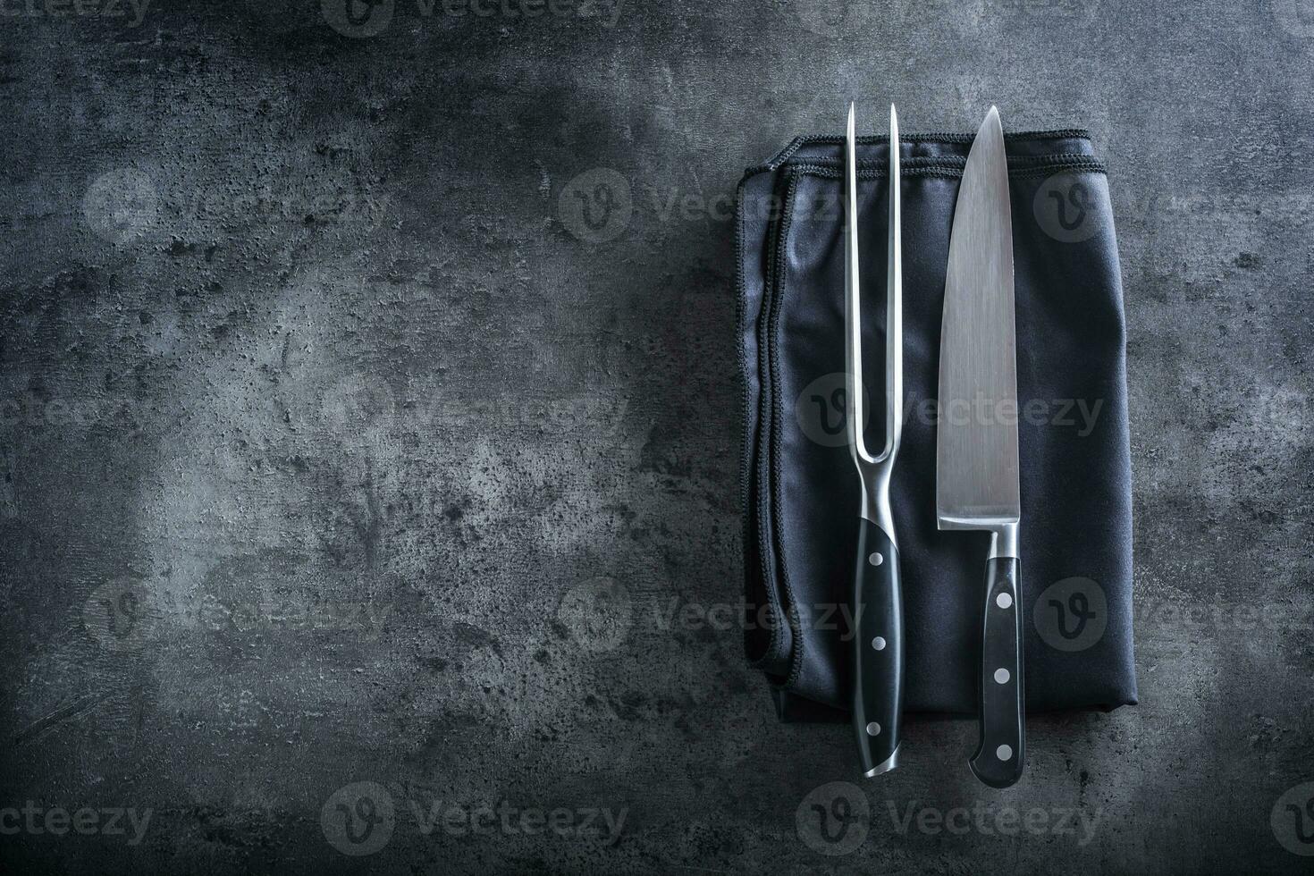 Fork and knife. Fork and knife black napkin tablecloth on concrete board photo