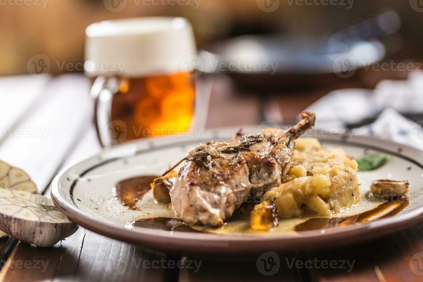 Iberian cutlet with mashes potatoes decoration and draft beere in pub or restaurant photo