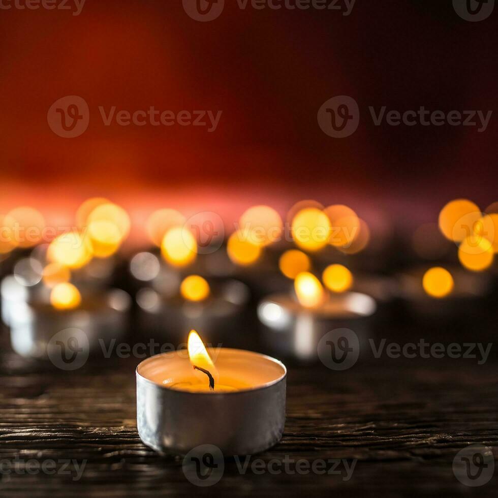 Many candles symolizing funeral religios christmas spa celebration birthday spirituality peace memorial or holiday burning at night photo