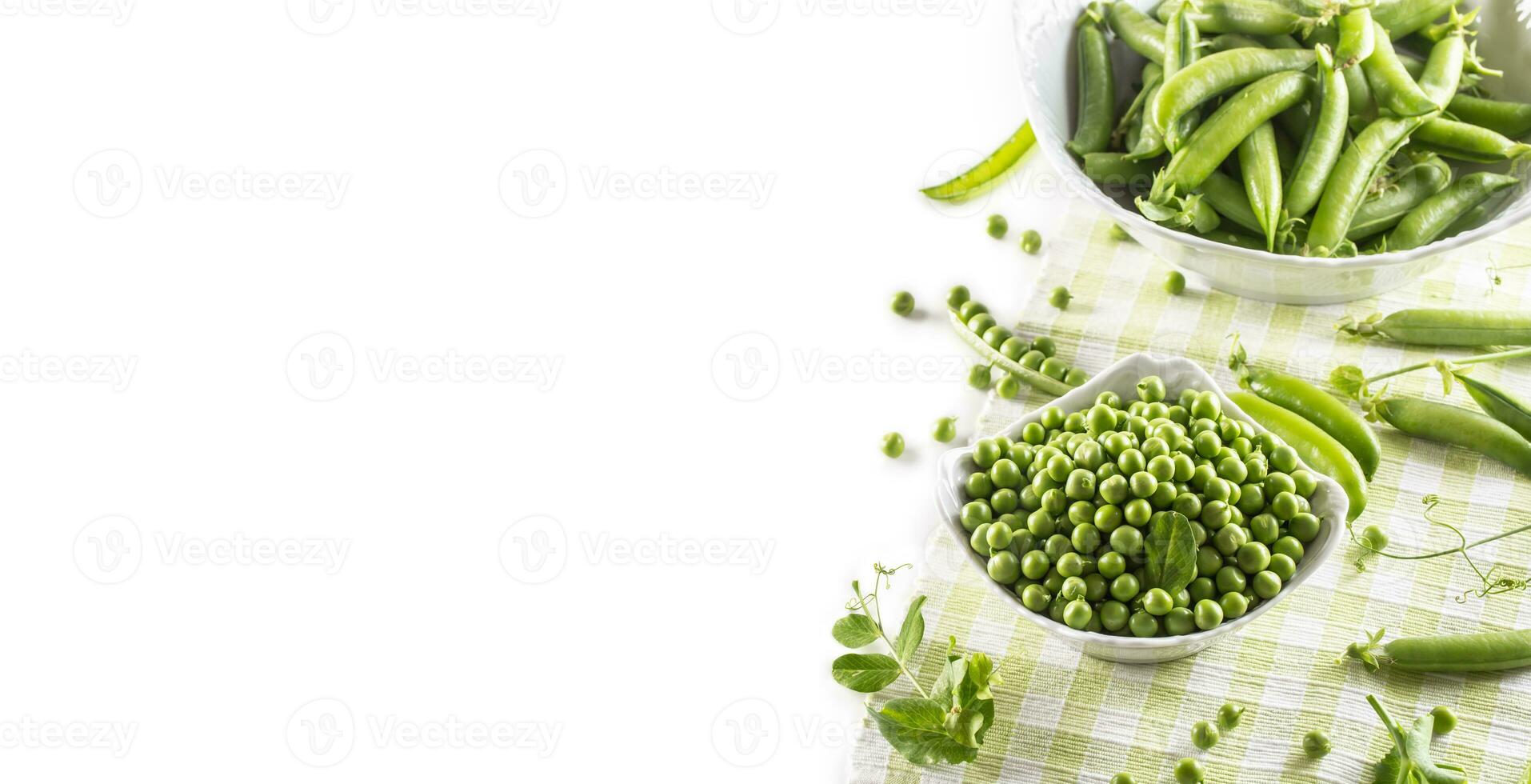 Green raw peas and pods in pocelain bow isolated on white background photo