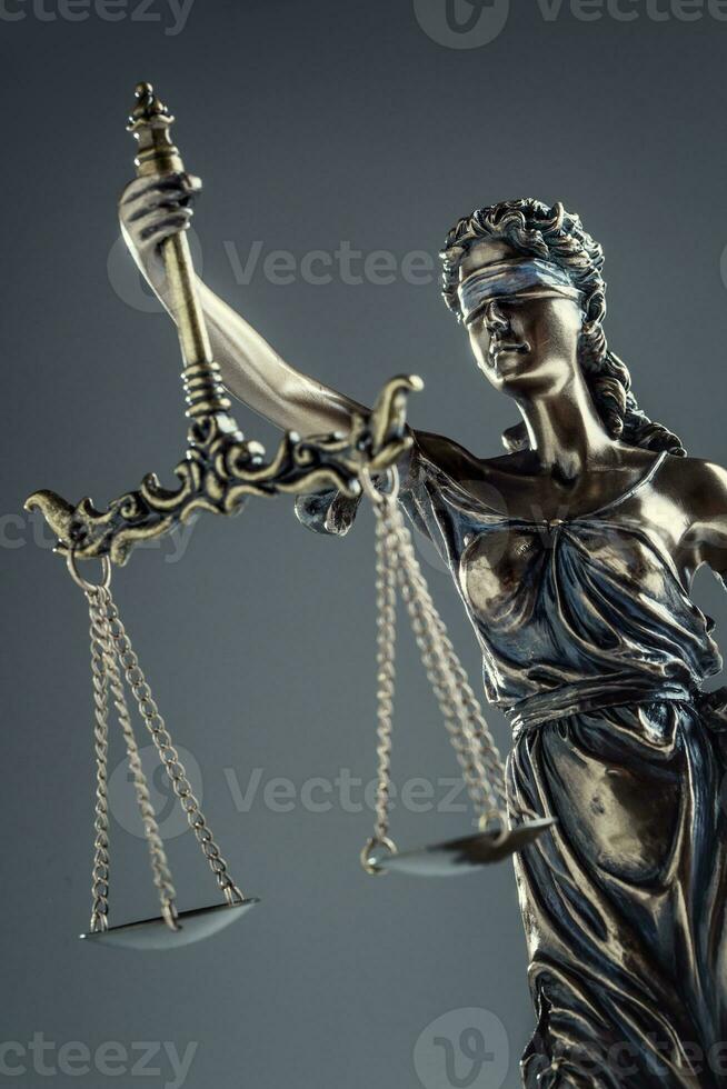 Statute of Justice. Bronze statue Lady Justice holding scales and sword photo