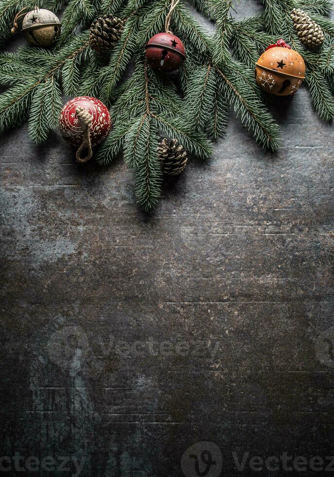 Top of view christmas decorations jingle bells fir tree pine cones on free concrete background photo