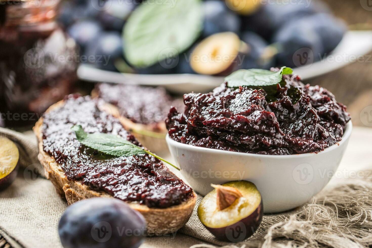 Breakfast from homemade plum jam bread and ripe plums. photo