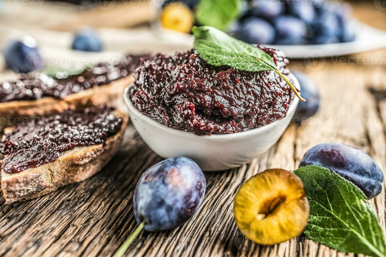 Breakfast from homemade plum jam bread and ripe plums. photo