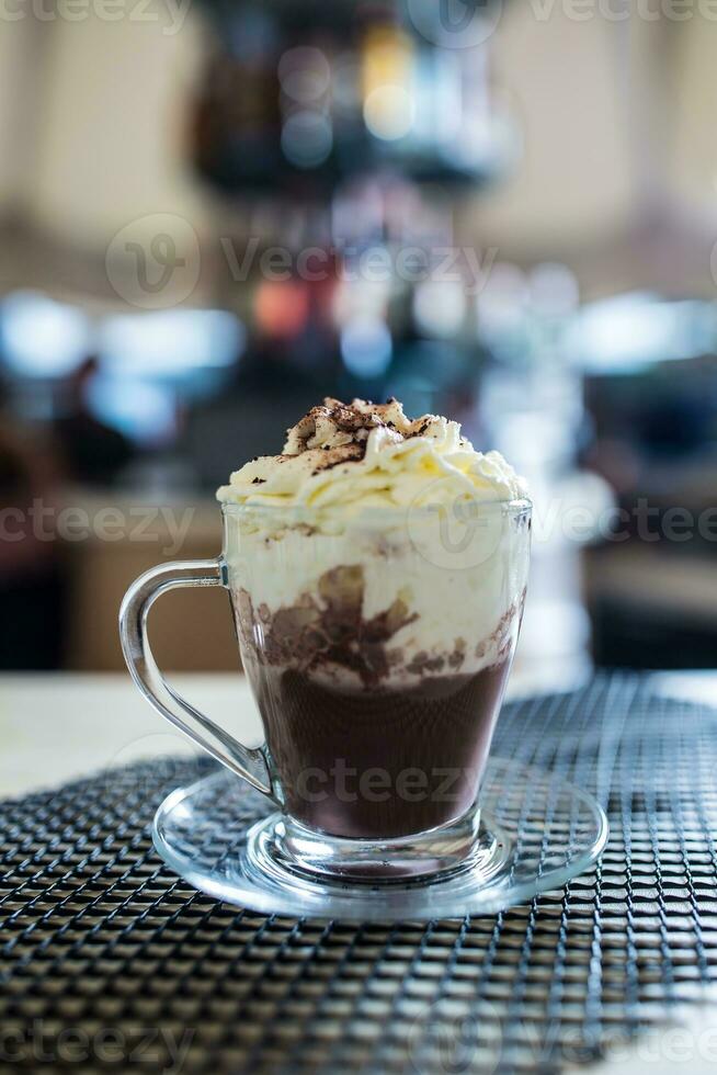 Cup with a hot chocolate and whipped cream. photo