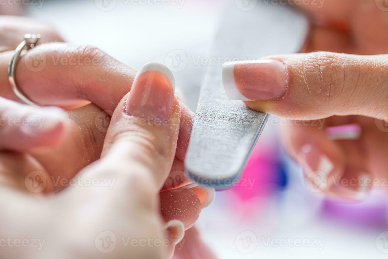 Close-up manicure of female nails in nail salon photo