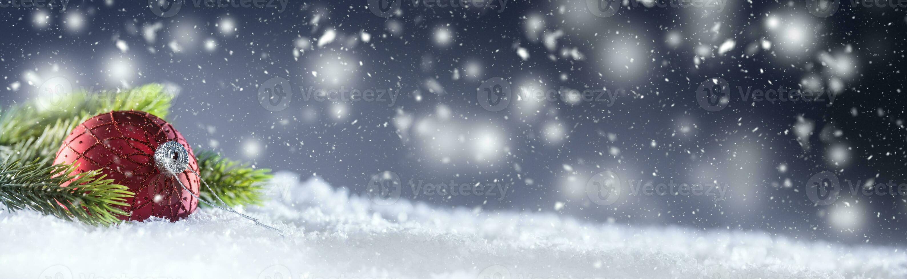 Christmas red Luxury ball in snow and abstract snowy atmosphere. photo