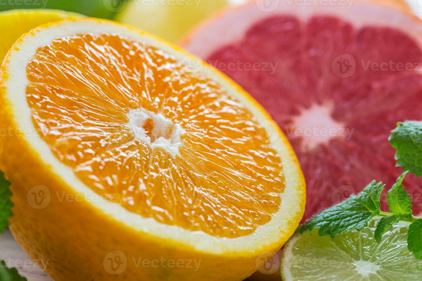 Citrus fresh fruit. Orange grapefruit lemon lime with mint leaves photo