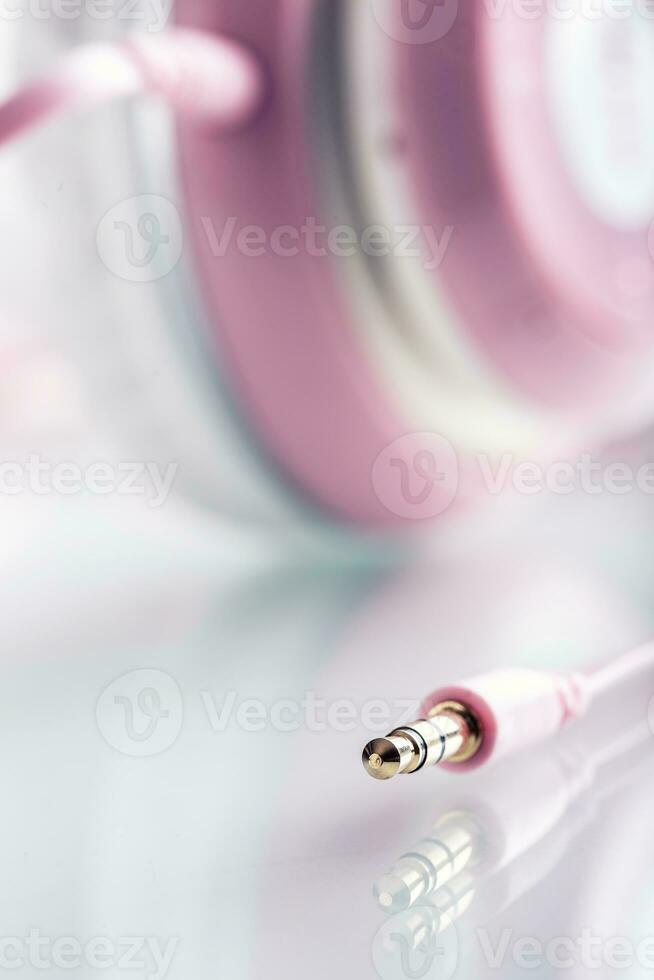 Headphones. Pink Headphones with jack connector - mirror reflection photo