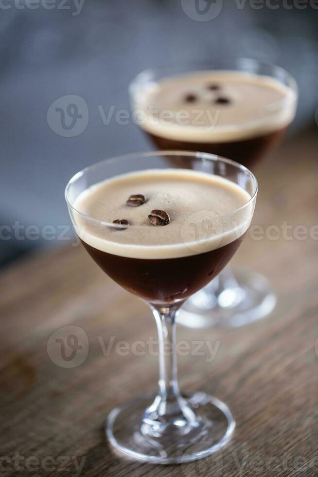 Espresso martini vodka short drink as a coffee cocktail inclduing coffee liqueur and vanilla syrup photo