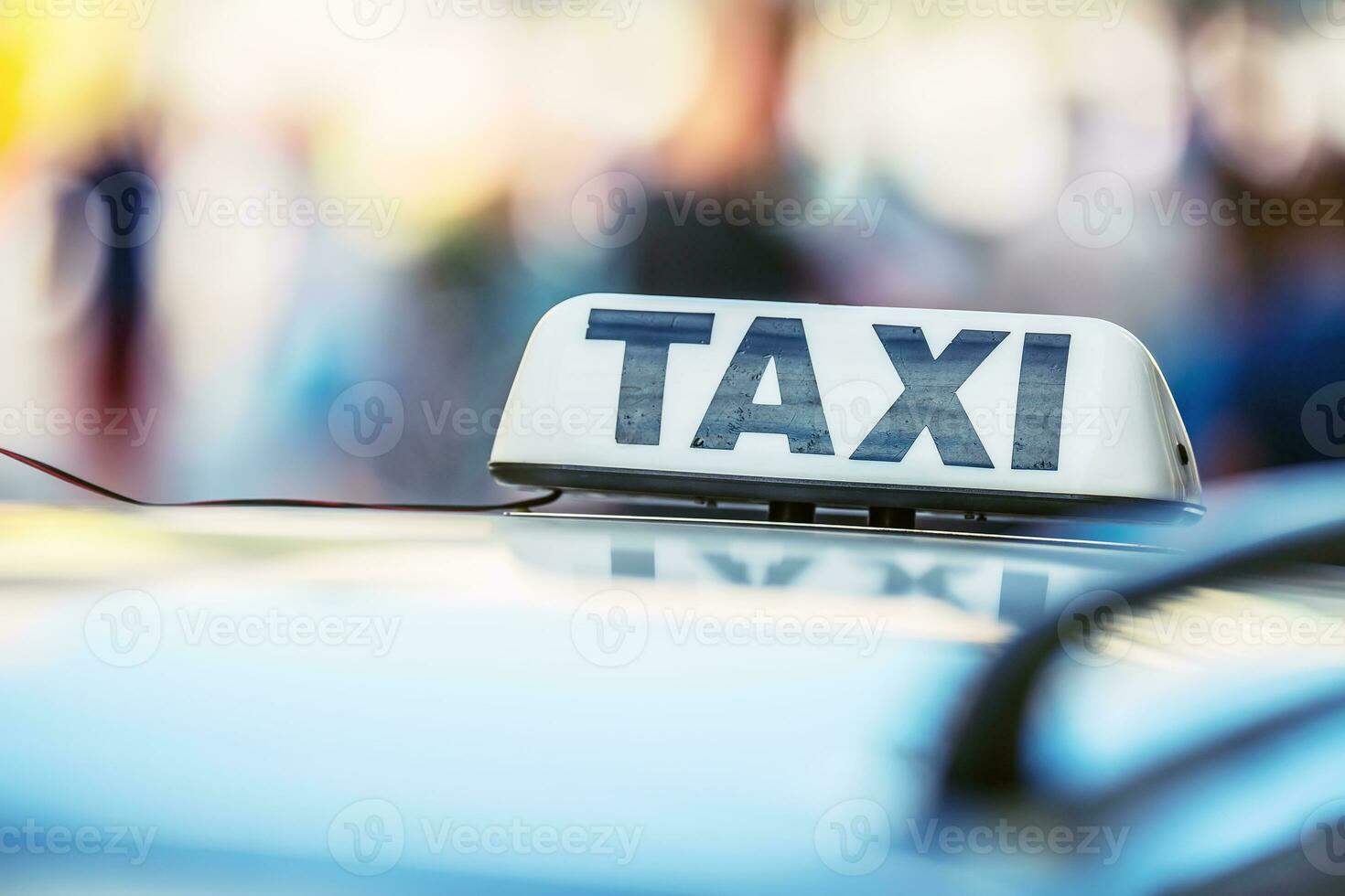 Taxi car waiting passengers in town.Taxi light on the cab of the car ready to transport the passengers photo