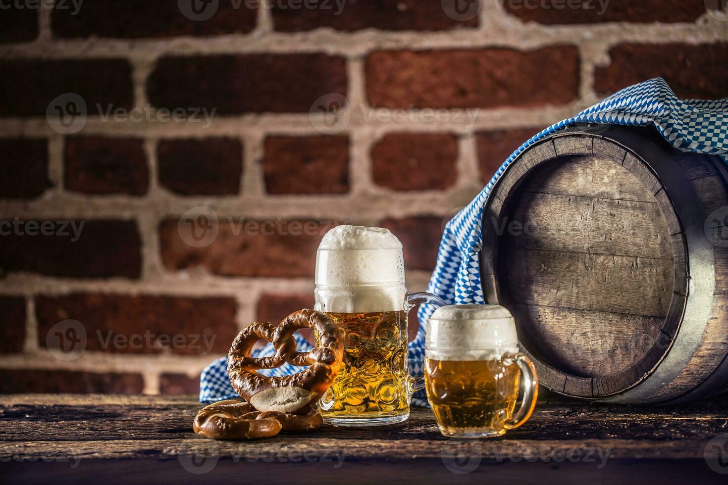 Oktoberfest large and small beer with pretzel wooden barrel and blue tablecloth photo