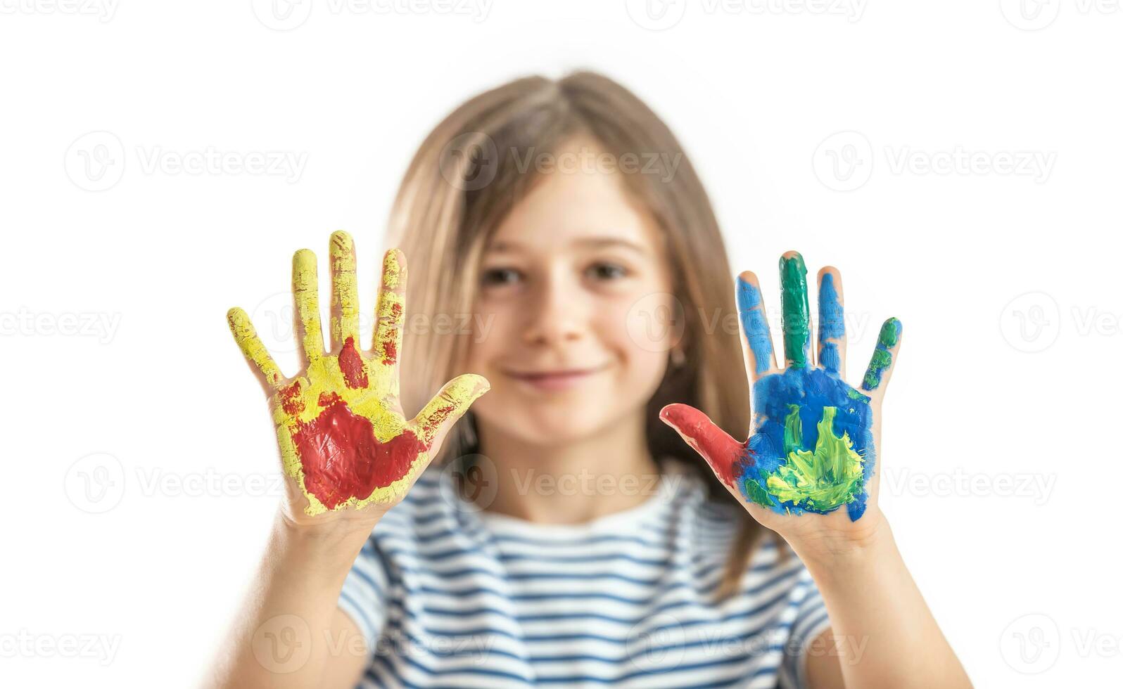 Little schoolgirl shows hands painted with watercolors - isolated on white photo