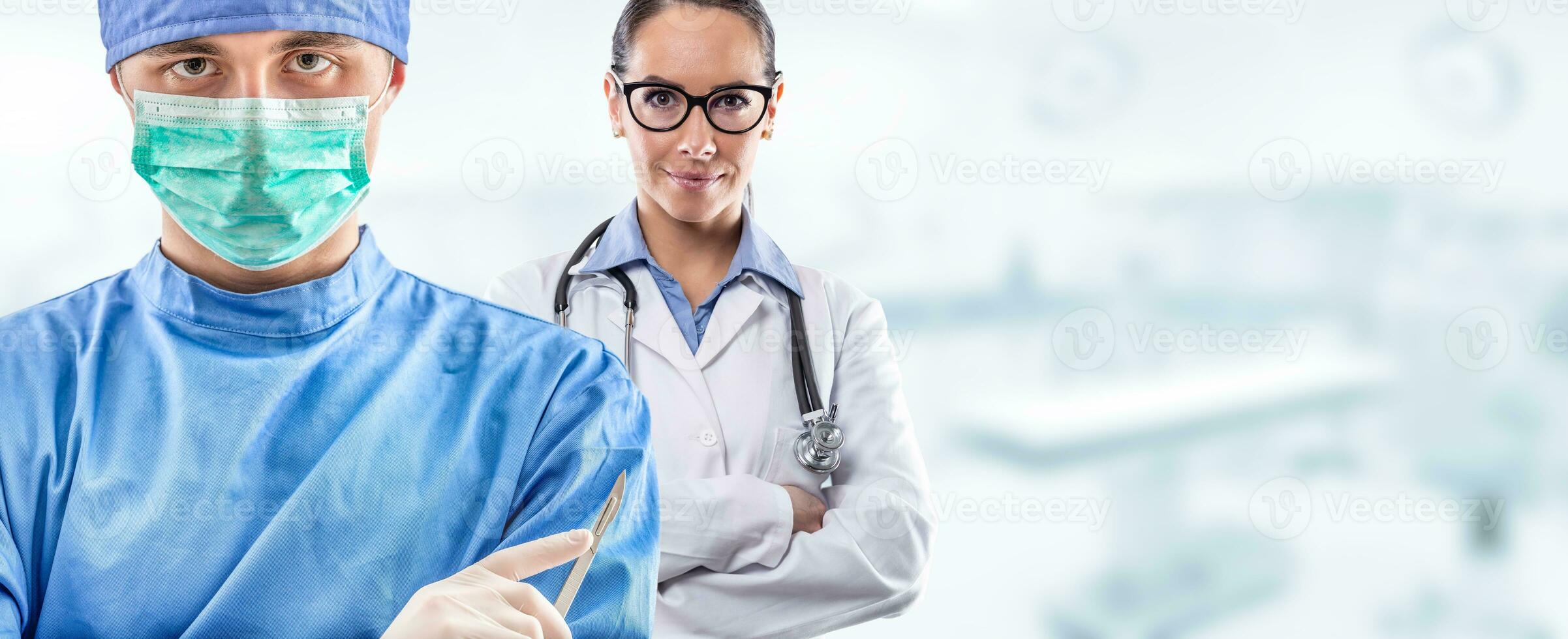 Young couple of surgeon and doctor in front of blurred the interior of the operating room or clinic photo