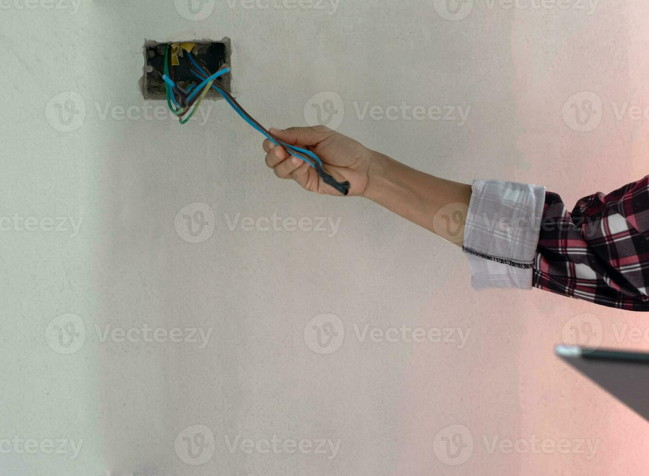 Electrician install holding electric wire working with on the construction site ,Repair, service and delopment od home concepts. photo