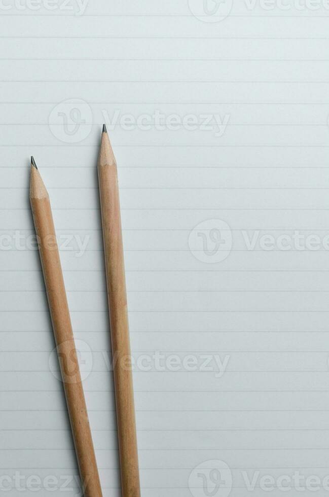 Pencils on Lined Paper with Copy Space Concept Background photo