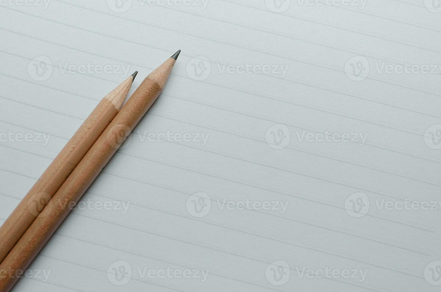 Pencils on Lined Paper with Copy Space Concept Background photo