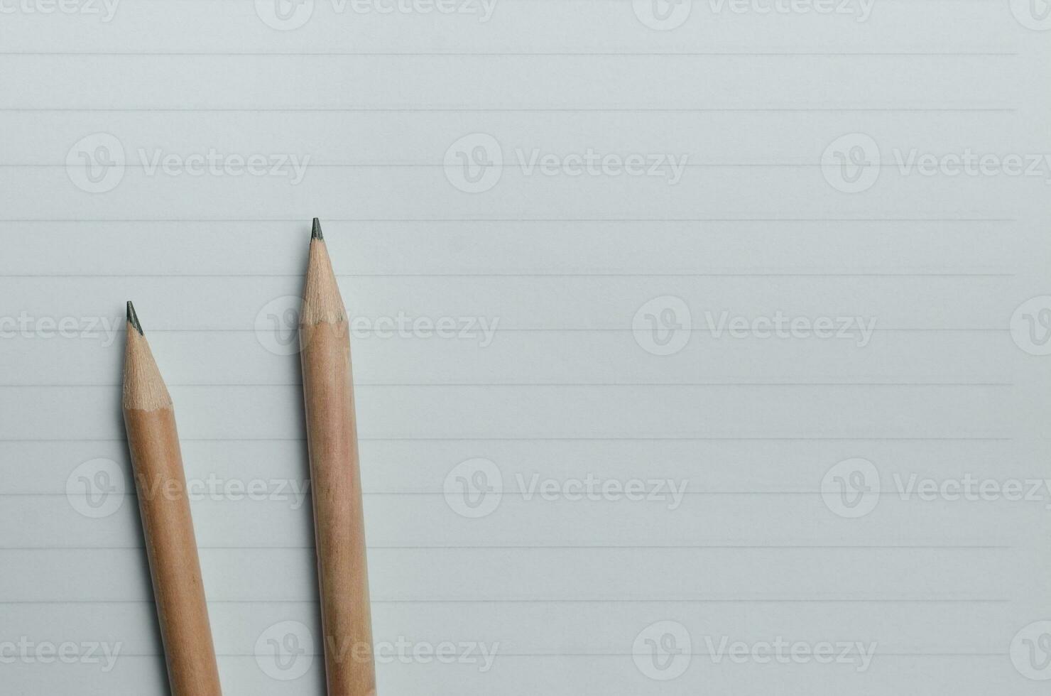 Pencils on Lined Paper with Copy Space Concept Background photo