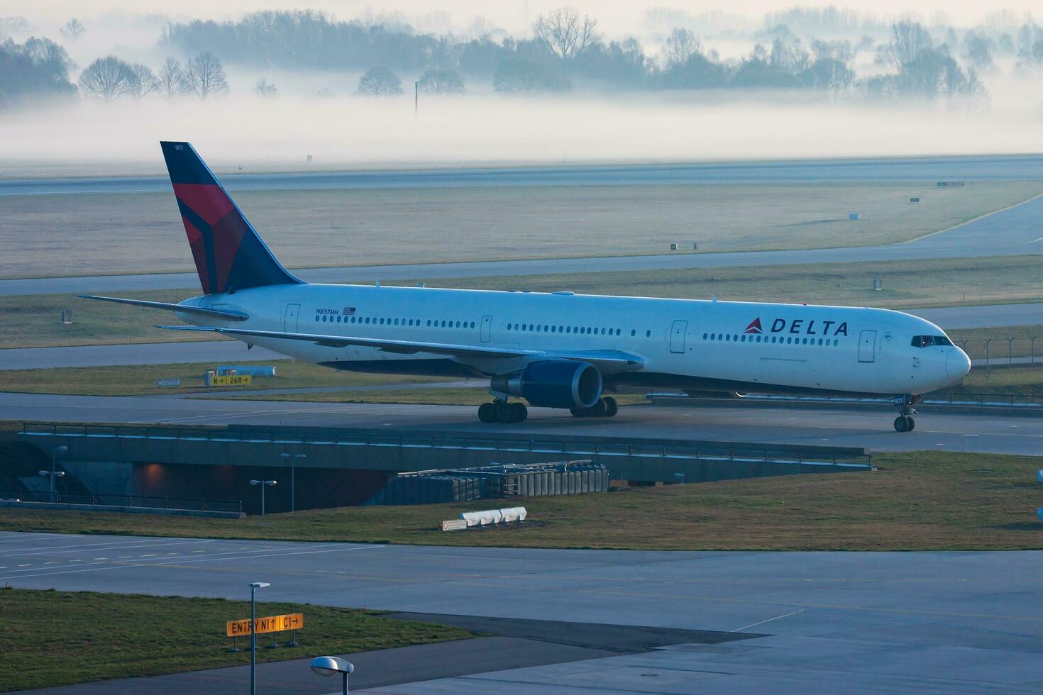 Delta Airlines passenger plane at airport. Schedule flight travel. Aviation and aircraft. Air transport. Global international transportation. Fly and flying. photo