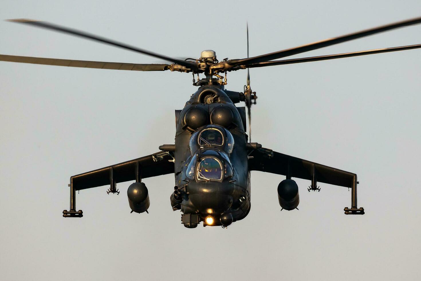Hungarian Air Force Mil Mi-24 Hind military attack helicopter. Flight operation. Aviation industry and rotorcraft. Transport and airlift. Fly and flying. photo