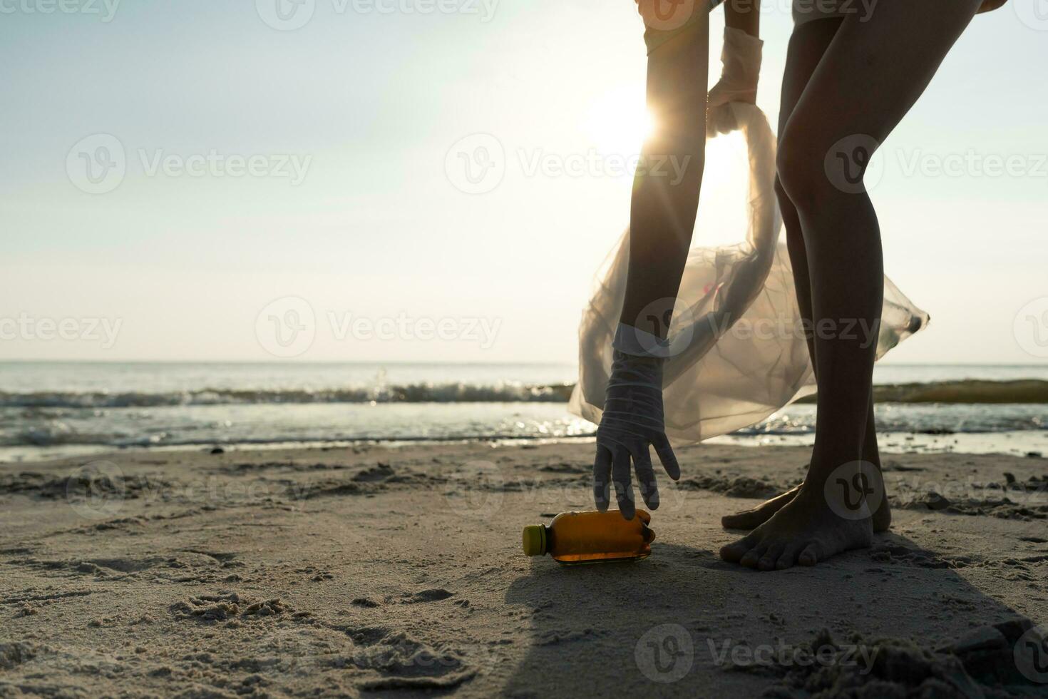 Save water. Volunteer pick up trash garbage at the beach and plastic bottles are difficult decompose prevent harm aquatic life. Earth, Environment, Greening planet, reduce global warming, Save world photo