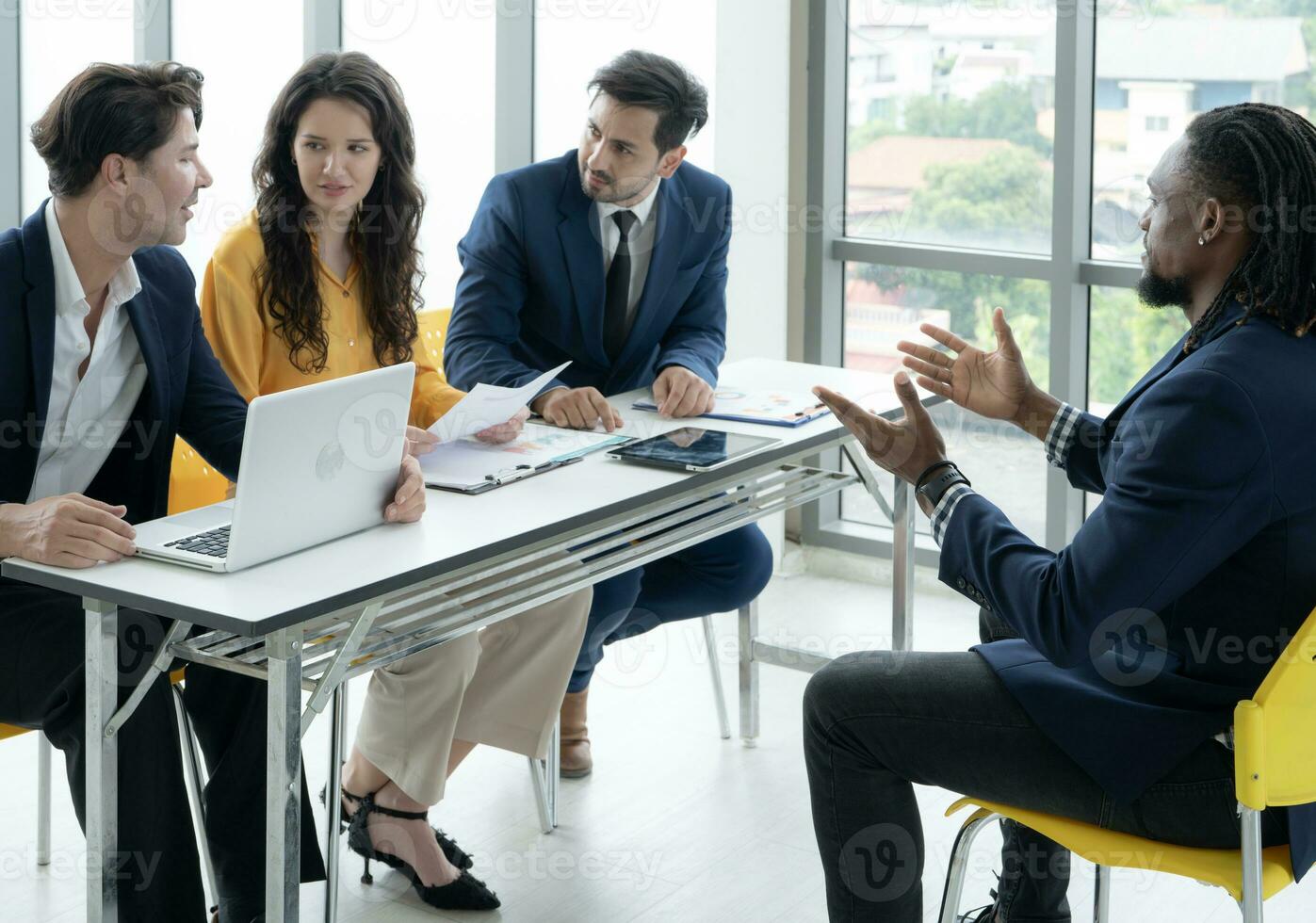 Job interview concept. Employer and diverse hr team doing job interview with a black man in business office. Job candidate talks with human resources team. Hiring, employment, and recruitment concept. photo