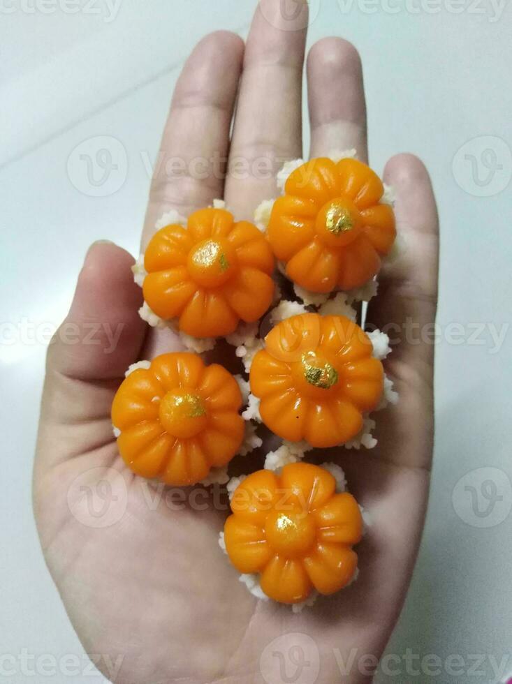 Dara Thong or Thong Ek Krachang is an ancient Thai dessert made from wheat flour, egg yolk, coconut milk, and sugar, with a base of melon seeds. The top is decorated with gold leaf that can be eaten. photo