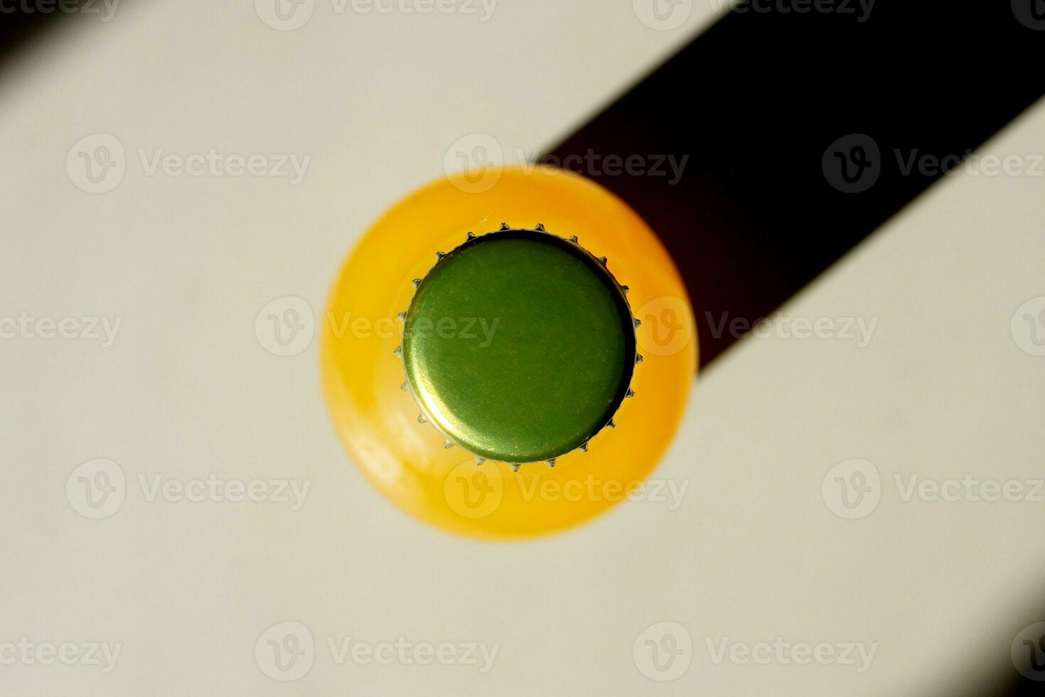 Lemonade Bottle and a Shadow on table overhead view. Closeup Flat lay Photography for Banner, Promotion, Ptinting, Poster. Fresh and juicy non-alcoholic Summer drink. photo