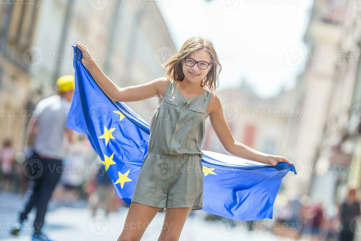 Cute happy young girl with the flag of the European Union photo