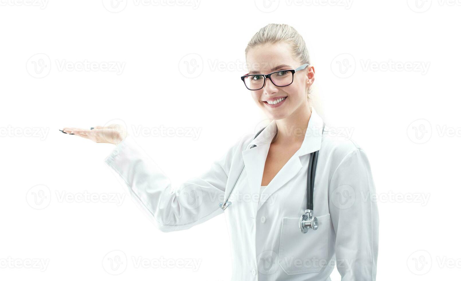 Portrait of a young beautiful woman doctor holding product isolated on white photo