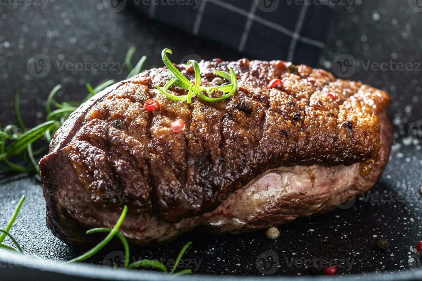Duck breast roasted in ceramic pan with salt spices and rosemary photo