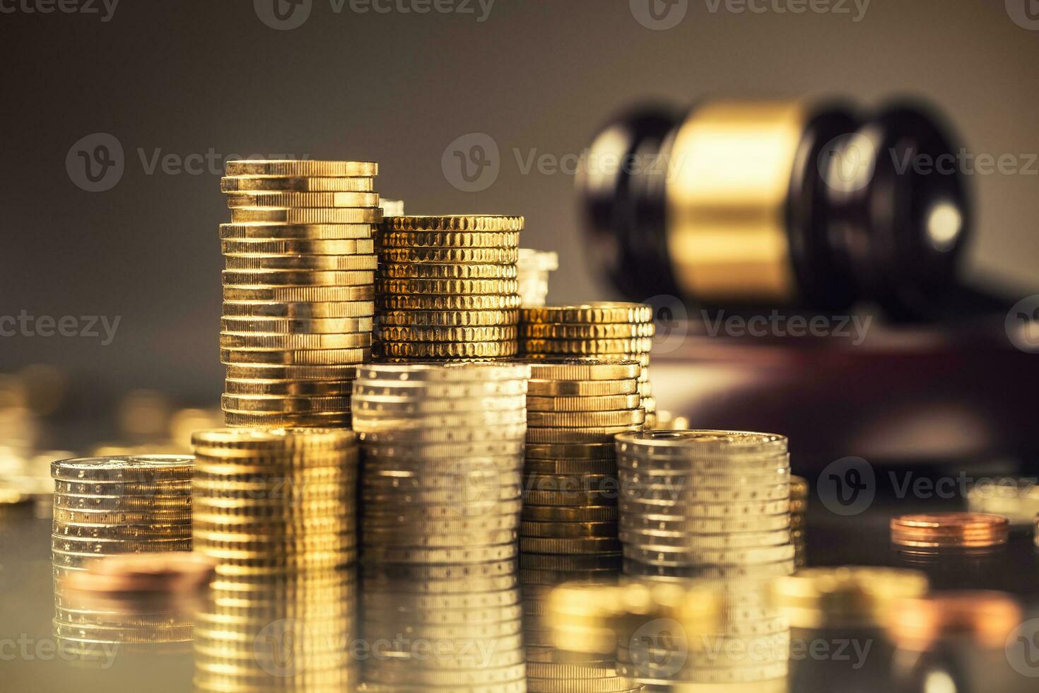 Towers with euro coins and justice hammer in the background photo