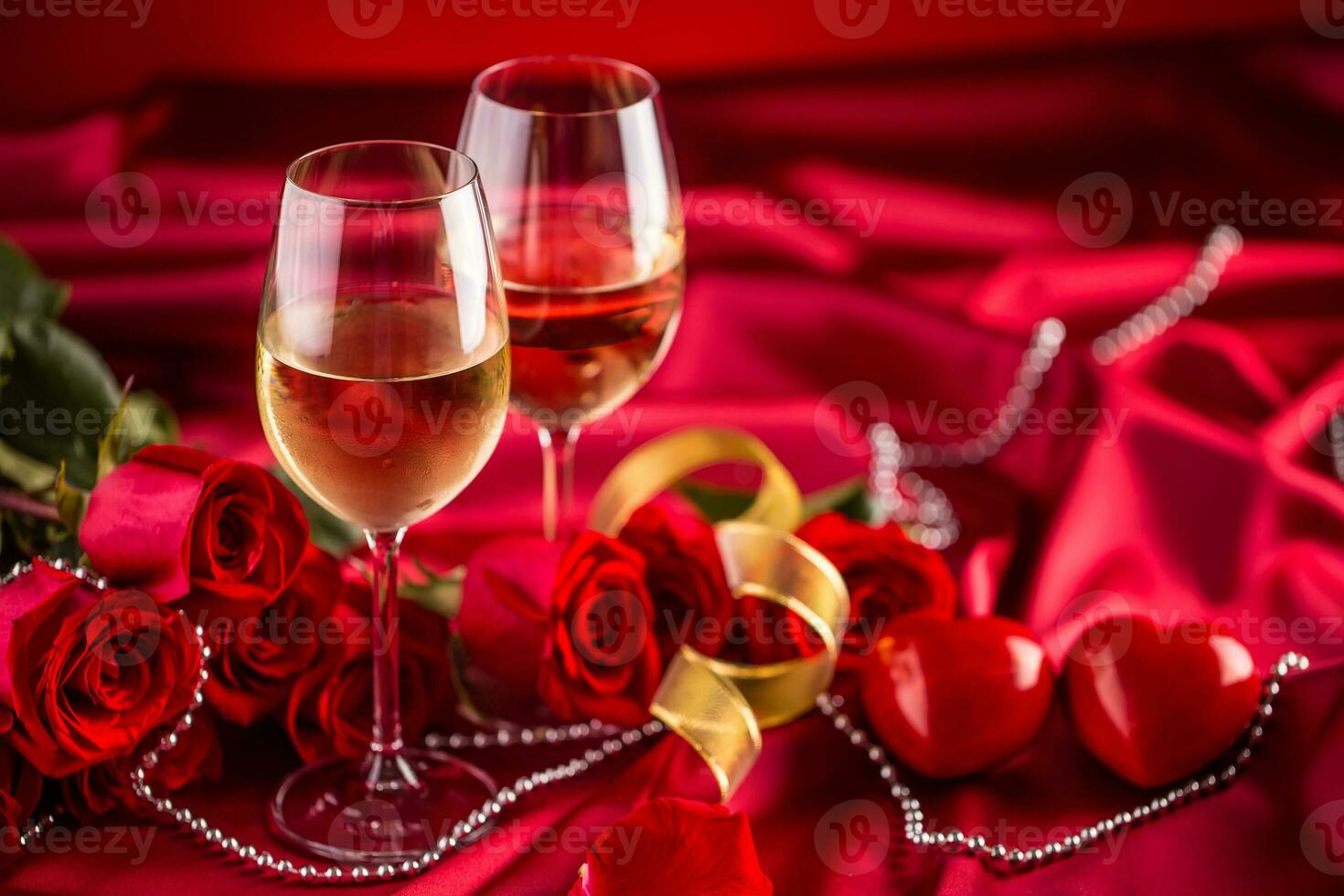 Valentines or wedding concept. Wine cups red roses and romantic setting for two in red. Greeting card for jubilee or aniversary photo