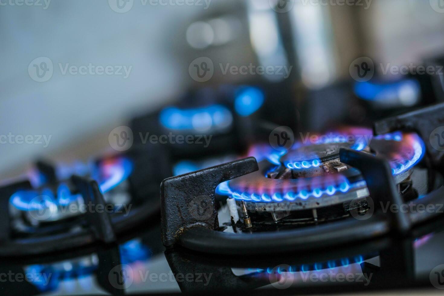 Close-up kitchen stove cook with blue flames burning photo