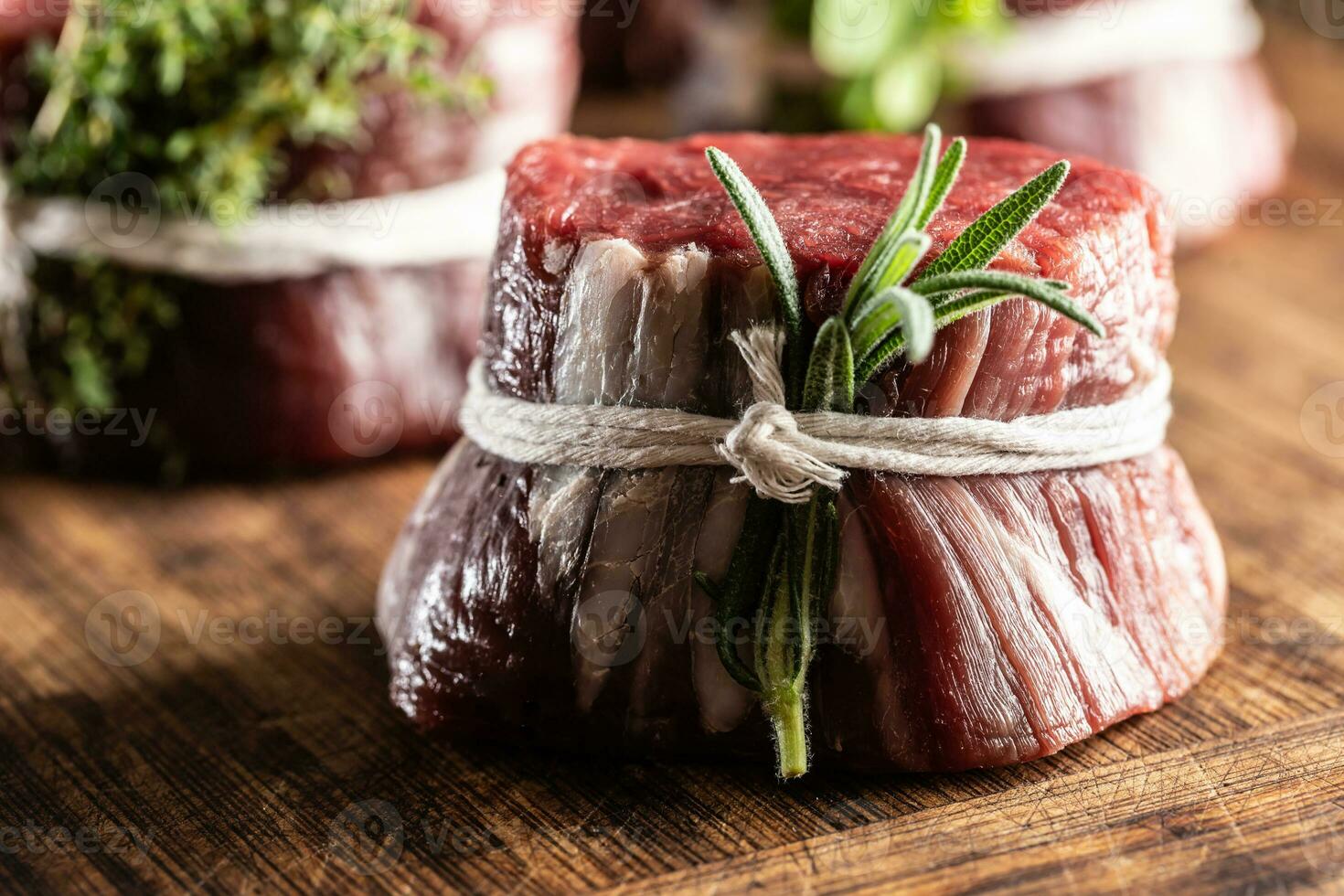 Raw steak portion with fresh rosemary photo